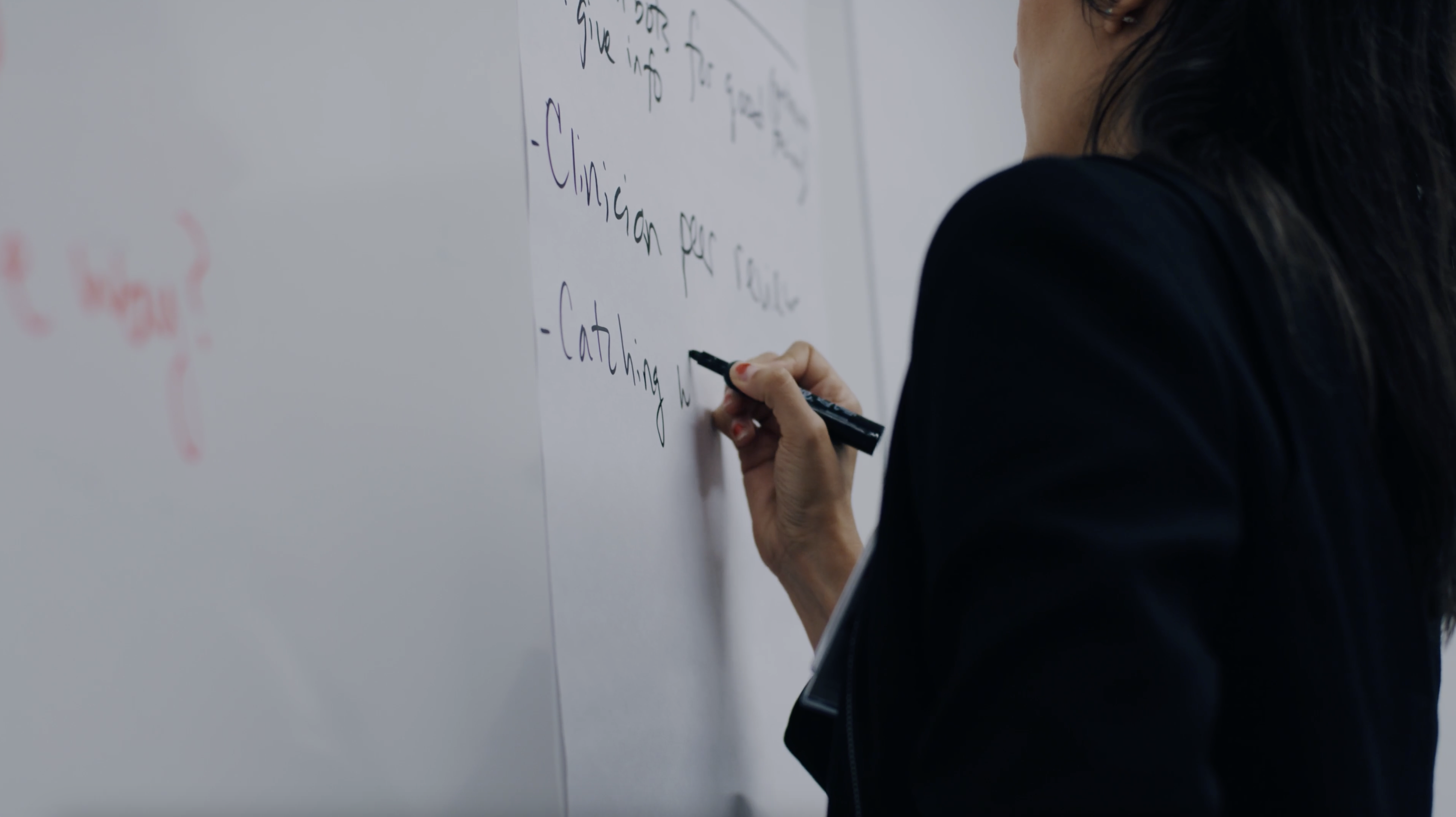 Anjana Sharma writing on the white board